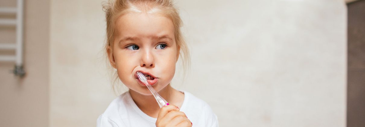 child with tooth brush