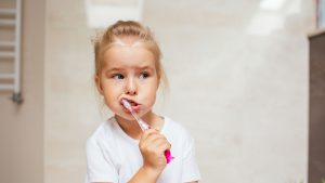 child with tooth brush